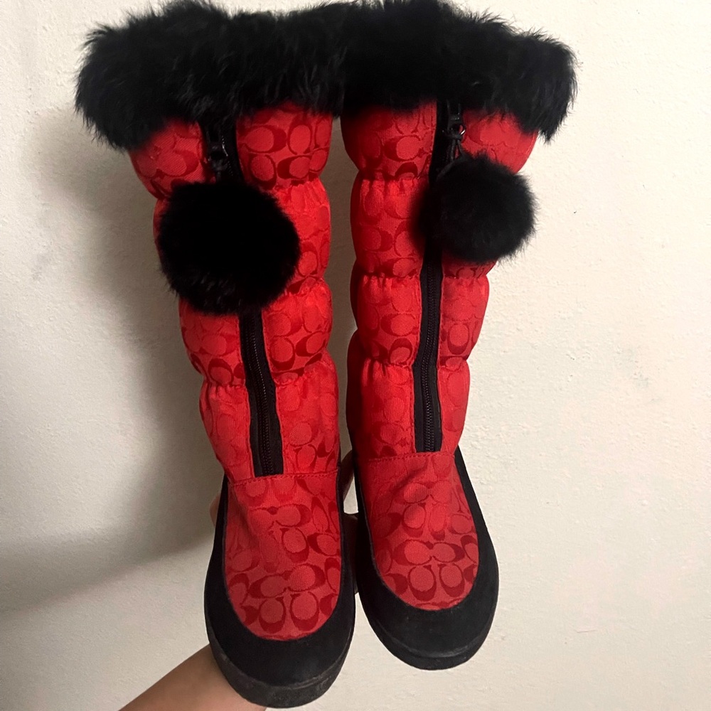 Red and black coach winter boots with black fur trim.